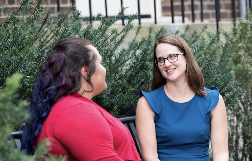 Academic Advisor adviising a Transfer student, seated on a bench